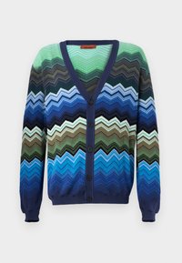 Cardigan cu un model zigzag multicolor. Fabricat din material tricotat, are un decolteu în V de culoare albastru închis, închidere cu nasturi și manșete cu nervuri.