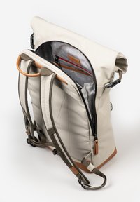 Roll-top backpack in light beige material with olive green straps, featuring a zippered main compartment and leather accents.