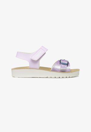 Sandalia infantil lila con correa ajustable en el tobillo y hebilla frontal, plantilla beige y suela blanca texturizada.