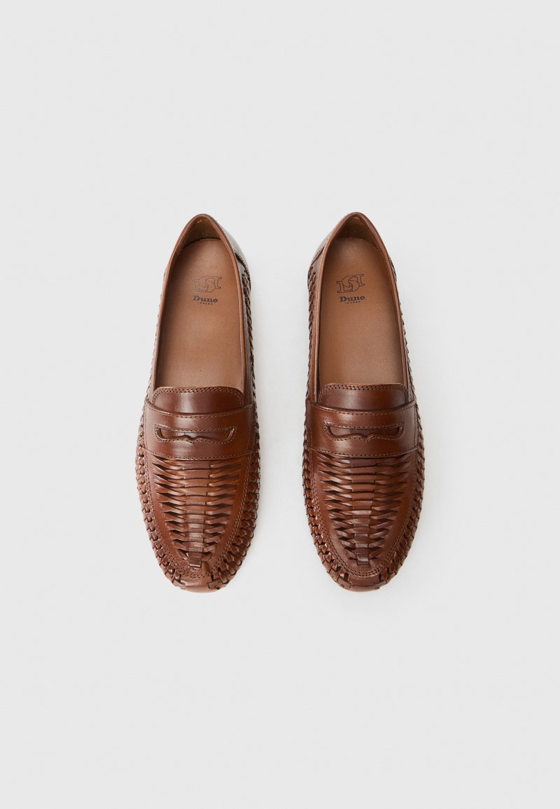 Brown leather loafers with woven upper, closed toe, and a smooth, polished finish. Features a stitched design and flat soles.