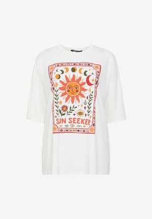 White T-shirt with colorful sun and moon phases graphic, floral elements, and "SUN SEEKER" text centered on the front.