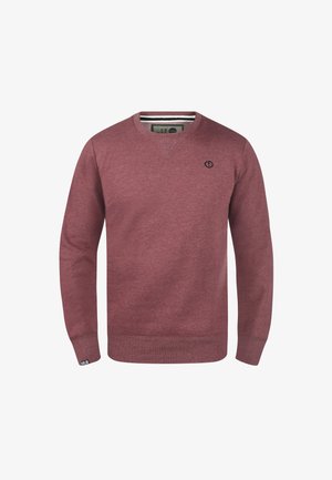 Sweat-shirt bordeaux avec un col en V, des poignets et un ourlet côtelés. Présente un petit logo noir sur la poitrine. Confectionné en tissu doux et texturé.