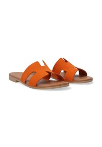 Orange suede slide sandals with cut-out straps, flat tan sole, and smooth texture. Features a minimalist design with open sides.