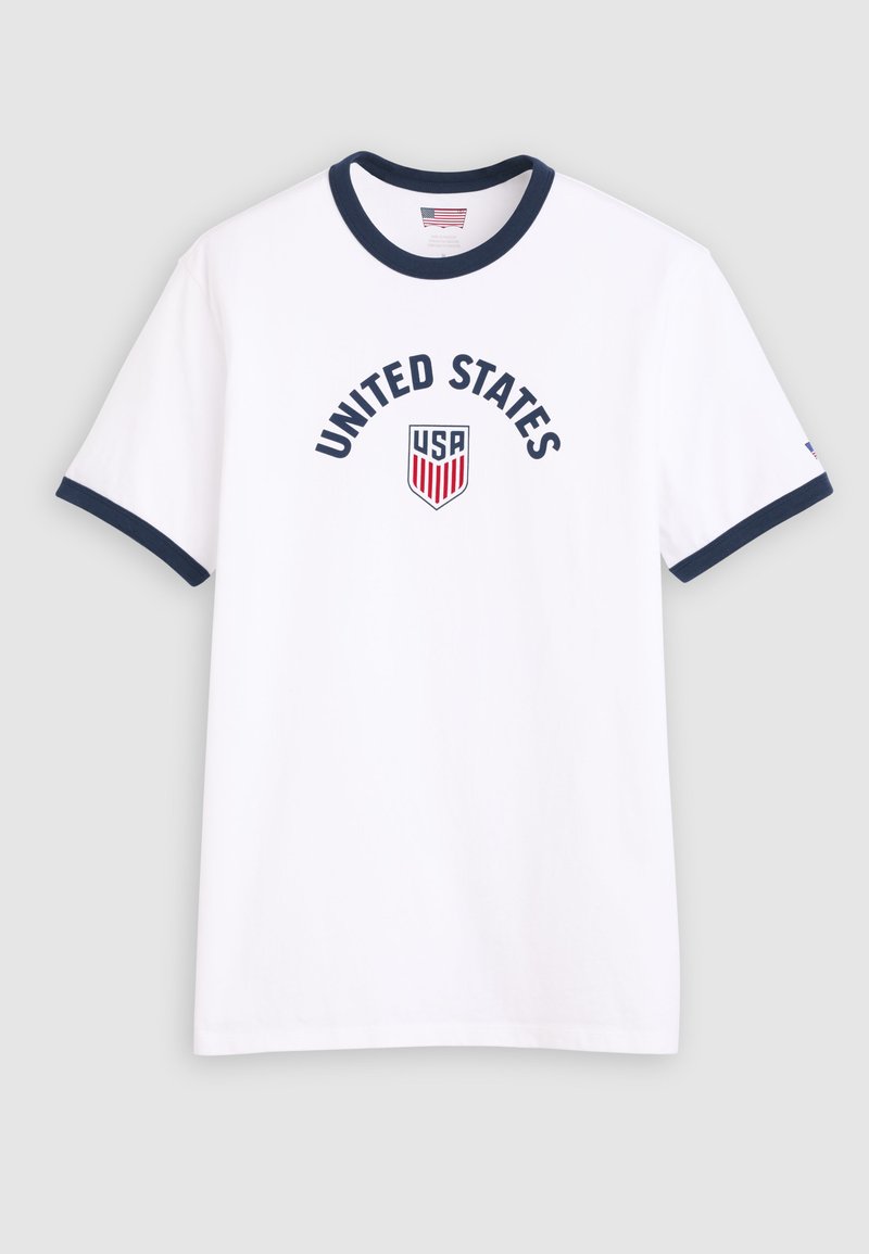White T-shirt with navy blue collar and sleeve edges, "UNITED STATES" text above a USA shield emblem in red, white, and blue on front.