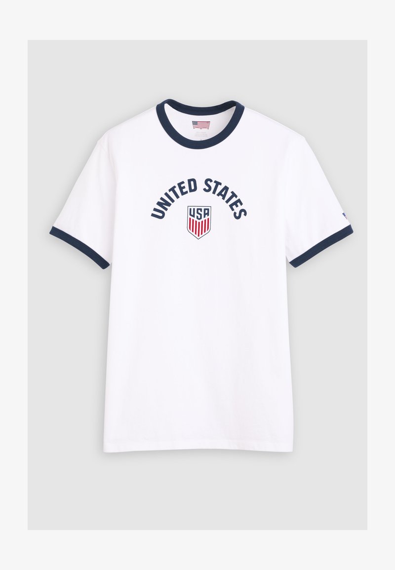 White T-shirt with navy blue collar and sleeve edges, "UNITED STATES" text above a USA shield emblem in red, white, and blue on front.