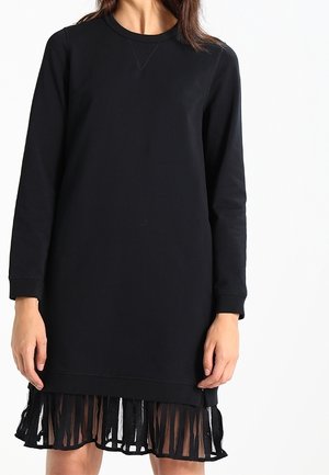 Sort sweatshirt-kjole med lange ærmer, rund halsudskæring og en kant med gennemsigtige frynser. Glat materiale og afslappet pasform.