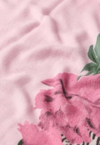 Rožinė medžiaga su švelniu tekstūru, kuri turi gėlių raštą tamsesnėmis rožinėmis ir žaliomis detalėmis, sukuriant sluoksniuotą ir natūralų vaizdą.