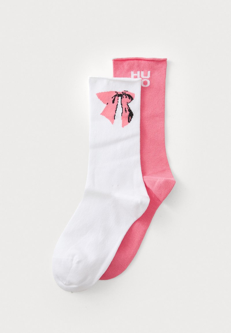Socks featuring a white base with a pink bow graphic and a pink solid color sock. Both have a soft fabric and ribbed cuffs.