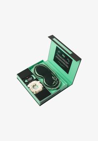 Set met groene cadeaubox omvat een donkergroene zijden slaapmasker, een crèmekleurige scrunchie, een zwarte haarband en een kaart met productdetails.