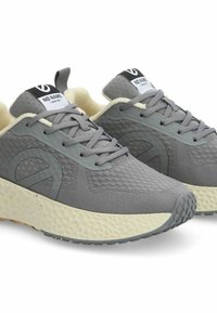 Chaussures de sport grises avec une tige en maille texturée, un col rembourré et une semelle claire à motifs. Présente un logo sur la languette.