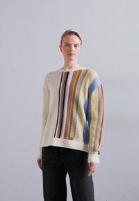 Cream-colored sweater featuring varying vertical stripes in blue, green, yellow, brown, and black. Ribbed texture and crew neckline.