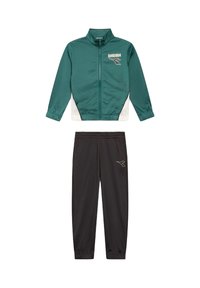 Giacca a zip verde e bianca con logo abbinata a pantaloni da jogging neri con vita elastica, caratterizzati da un piccolo logo sulla coscia.