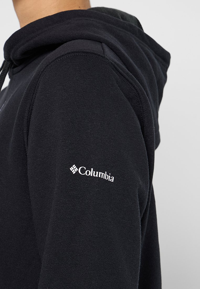 Schwarze Kapuzenjacke aus weichem Baumwollgemisch. Verfügt über eine Vordertasche, eine verstellbare Kordelzugkapuze und ein weißes Columbia-Logo auf dem Ärmel.