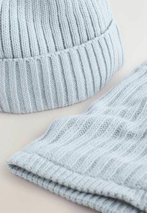 Gorro de punto azul claro con un diseño acanalado y un borde doblado, combinado con una bufanda acanalada a juego en el mismo color y textura.