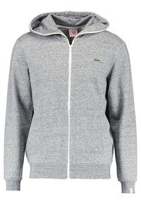 Sudadera gris con cremallera, hecha de una tela suave, que presenta una capucha, puños acanalados y un logo verde bordado en el lado izquierdo del pecho.