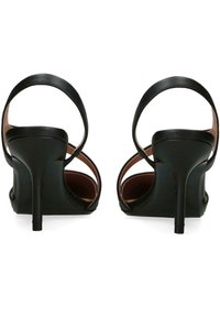 Černé sandály na vysokém podpatku s dvěma tenkými kotníkovými pásky, otevřenou špičkou a elegantním zakřiveným podpatkem. Hladký kožený materiál s matným povrchem.