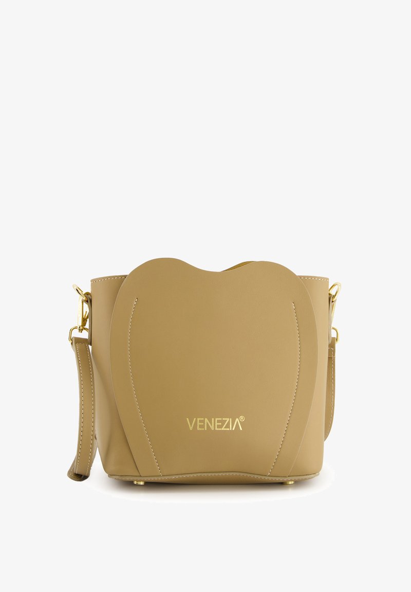 Sac à main en cuir marron clair avec un design en forme de cœur, garnitures dorées, bandoulière réglable et logo de la marque en relief. Texture lisse, détails de couture minimaux.