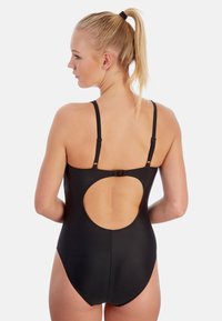 Maillot de bain une pièce noir avec bretelles réglables. Dispose d'un dos découpé en oval et d'une finition lisse et élégante. Convient pour la natation.