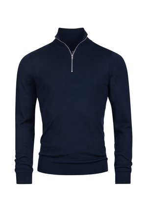 Marinen blå genser laget av et glatt strikket stoff. Har høyt skjortekrave med sølvglidelås og tettsittende mansjetter.