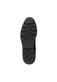 Suela de zapato de goma negra con superficie texturizada, que presenta un patrón de banda de rodadura detallado y una etiqueta grabada que dice "WITTCHEN handmade".