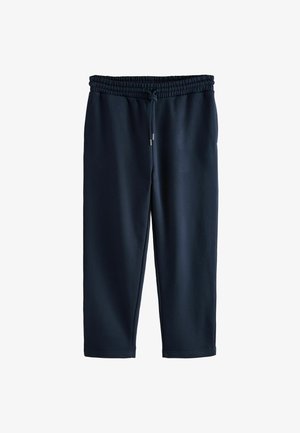 Tumed sinine dressipüksid, mis on valmistatud kergest kangast, elastse vöökoha, reguleeritava nööriga ja kitsenevate jalgadega, millel on sile tekstuur ja juhuslik disain.