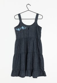 Robe sans manches bleu foncé avec un design à volants, ornée d'une broderie florale sur la poitrine et d'une fente à bouton au dos.