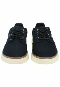 Navy canvas material shoes with white rubber soles, round toe, tonal laces, and brown accents on the sole edge.