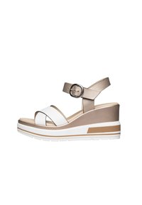 Wedge sandals with a white and metallic gold upper. Crossed straps and adjustable ankle strap. Thick, white platform with brown accent.