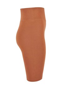 Magas derékú, térdig érő leggings, egyszínű rozsdás árnyalatban, rugalmas anyagból készült, sima tapintással és látható varrások nélkül.