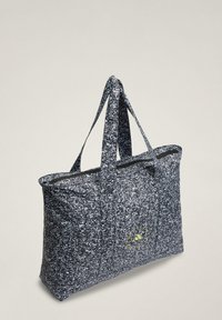 Gray and black tote bag made of textured fabric, featuring two sturdy handles and a bright yellow logo accent on one side.