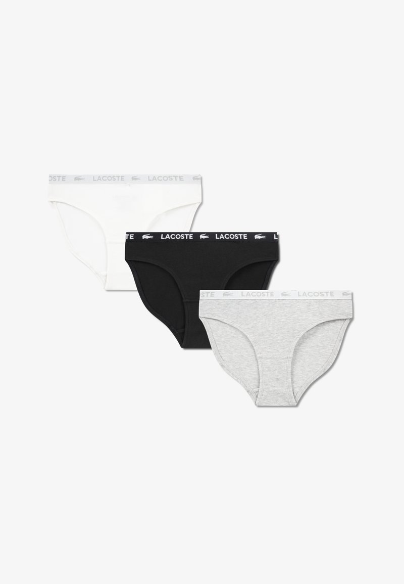 Three pairs of women’s briefs in white, black, and gray. Each features a waistband with the "Lacoste" logo. Soft cotton material.