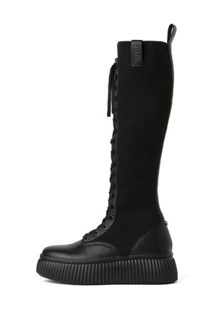 Botte haute noire à lacets avec tige en tricot côtelé, semelle épaisse crantée et languette en haut, mélange de cuir et de tissu.