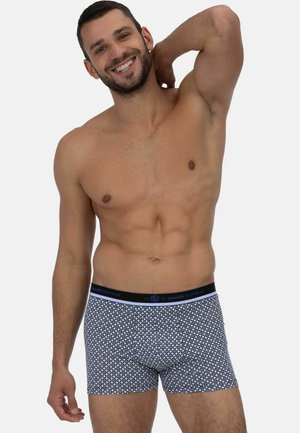 Badehose in Marineblau mit geometrischem Muster, aus weichem Material. Der elastische Bund hat ein in Blau gehaltenes Logo. Bequemer Sitz.