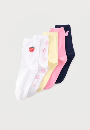 Cinq paires de chaussettes basses blanches avec des motifs de fraises et de bonbons, jaunes, roses et bleu marine avec un papillon rose, disposées en chevauchement.