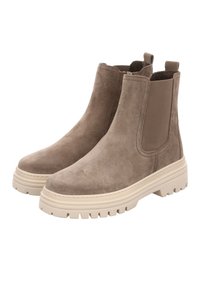Botas Chelsea de ante marrón con paneles laterales elásticos y una suela beige gruesa. Presentan una puntera redondeada y una superficie superior texturizada.