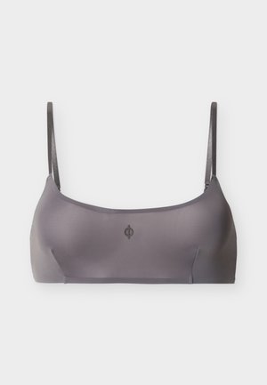 Glatte graue Bralette mit dünnen, verstellbaren Trägern und einem kleinen runden Logo in der Mitte vorne.