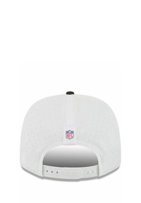 White baseball cap featuring a perforated design and an adjustable snapback closure. Includes NFL logo tag on the back.
