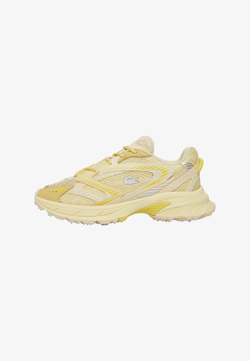 Light yellow athletic shoes with mesh upper, tonal accents, and a textured rubber sole. Features a raised logo on the side and lacing system.