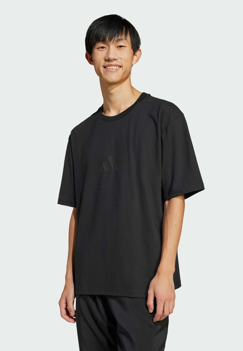 Black short-sleeve t-shirt in a relaxed fit, made of smooth fabric, featuring a subtle logo detail on the front.