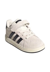 Light grey suede sneaker featuring black stripes and a Velcro strap, with a textured upper and a rubber sole.