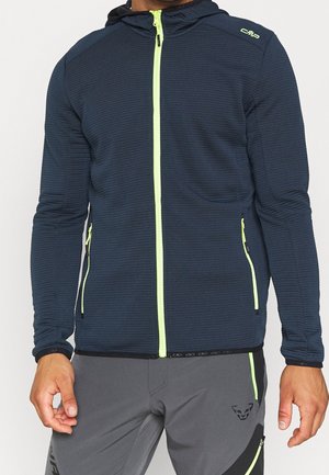 Granatowa kurtka z kapturem o teksturowanym wykończeniu, z pełnej długości neonowożółtym zamkiem błyskawicznym i dwoma bocznymi kieszeniami na zamek.