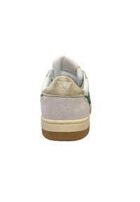 White sneaker with green suede accents, gold metallic heel tab, and beige rubber sole. Features a textured back panel and padded collar.