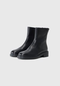 Black leather ankle boots with a smooth texture, rounded toes, and a low block heel. Lined interior visible at the top edge.