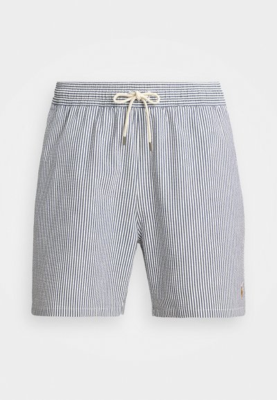 Pasiasty strój kąpielowy w granatowo-białe paski, z elastycznym pasem w talii z troczkami, bocznymi kieszeniami oraz subtelnym logo na końcu.