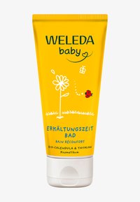 Tubetto giallo con illustrazioni di fiori bianchi e coccinelle. Il testo include "Weleda baby" e "Erkältungszeit Bad," che indicano un prodotto da bagno per bambini.