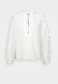 Valkoinen puuvillapaita mandariinikauluksella, etupaneelissa napitus ja runsaat pitkät hihat. Sujuva pinta, jossa on hienovaraisia kerrostumisdetaljeja olkapäillä.