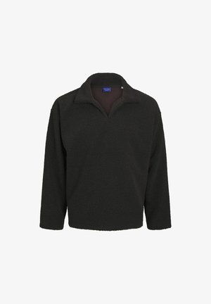 Pull de polaire sombre avec un col zippé mi-hauteur, des manches longues et une surface douce et texturée. Pas de motifs ou d'accents visibles.