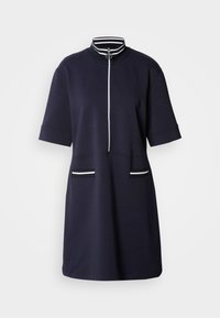 Navy short-sleeve dress with a high collar and front zipper. Features white striped accents on the collar and two front pockets.