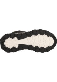 Semelle de chaussure de sport en noir et blanc avec des motifs de crampons profonds et robustes ainsi que des surfaces texturées, conçue pour une adhérence sur divers types de terrains.