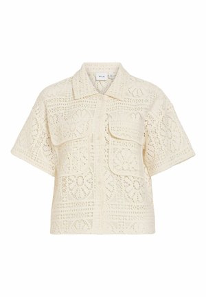 Kremasta srajca kratkih rokavov z gumbi, z vzorcem cvetlične čipke in dvema sprednjima žepoma s poklopcem.